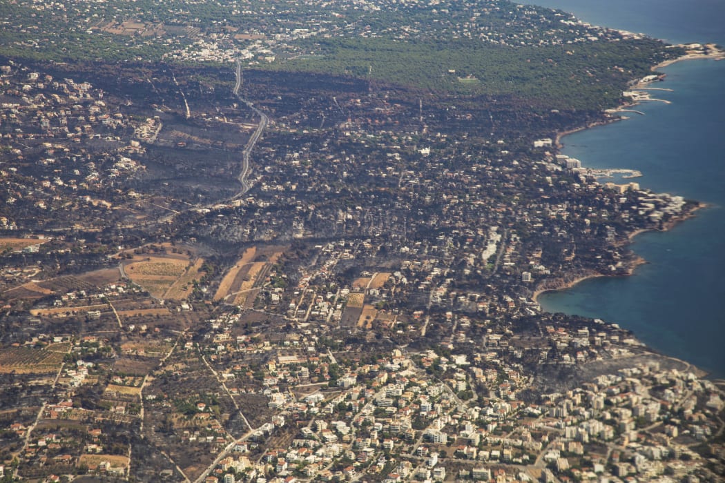Pictures of burnt Mati and Neos Voutsas from an airplane window after take off, the area is in eastern Attica near Athens after the fire.