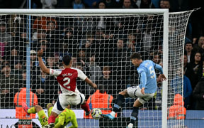 Manchester City defender John Stones scores the equalising goal against Arsenal in their English Premier League clash at Etihad Stadium in Manchester.