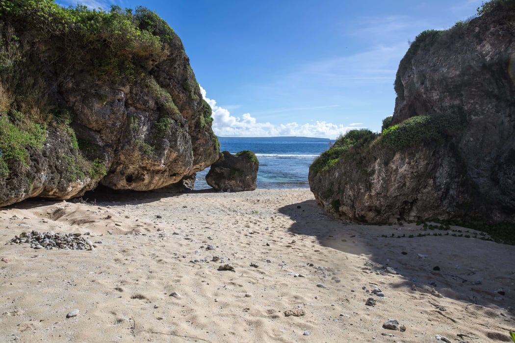 A beach in Tinian, CNMI, used for subsistence fishing and recreation by local residents.  Proposed US military live-fire training would prevent access to this beach much of the year. Saipan is visible just across the water.