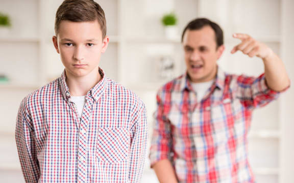 A photo of a father and son dressed having a quarrel at home.