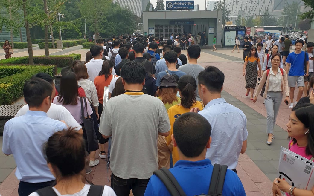Long line waiting above ground to even get into the station