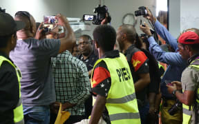PNG Electoral Commissioner Patilias Gamato under pressure at a media conference