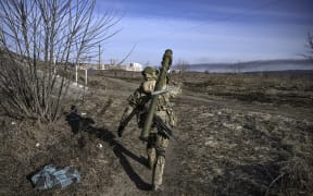 A Ukranian serviceman walks towards the front line in the city of Irpin, northern Ukraine, on 12 March 2022.