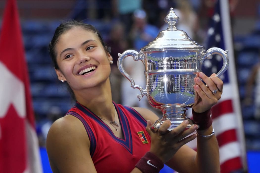 Britain's Emma Raducanu celebrates with the trophy after winning the 2021 US Open Tennis tournament women's final match against Canada's Leylah Fernandez at the USTA Billie Jean King National Tennis Center in New York, on September 11, 2021.
