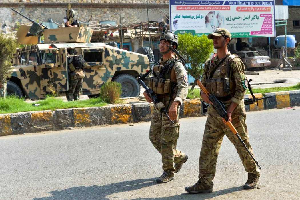 Afghan soldiers patrol outside a prison during an ongoing raid in Jalalabad on 3 August 2020.