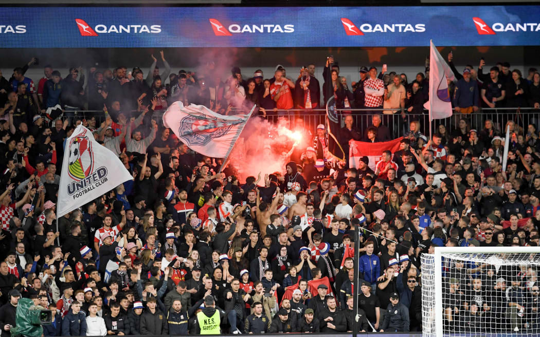 Sydney United fans light a flare during the Australia Cup Final football match between Sydney United FC and Macarthur FC in Sydney, 2022.
