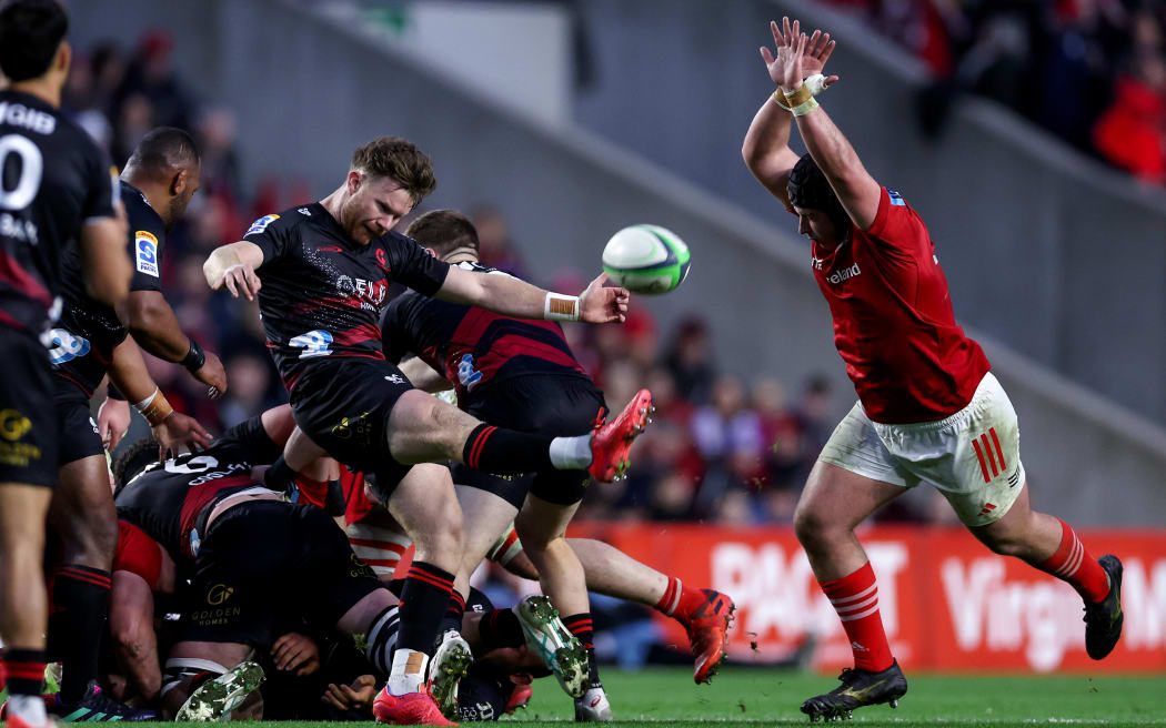 Mitch Drummond takes a box kick despite the attention of Eoghan Clarke of Munster.