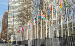 United Nations Headquarters in Manhattan. Flags of All Nations Waving in Front of the Building. New York City, USA