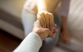 Man giving hand to depressed woman,Psychiatrist holding hands patient,Meantal health care concept,Selective focus