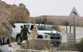 An Israeli soldier walks up to a military vehicle close to the Mount Harif military base near the city of Mitzpe Ramon in Israel's southern Negev desert, adjacent to the border with Egypt, on June 3, 2023.