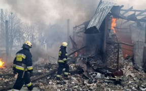 Firefighters are seen at the site after airstrikes hit civil settlements as Russian attacks continue on Ukraine in Dnipro, Ukraine on March 11, 2022.