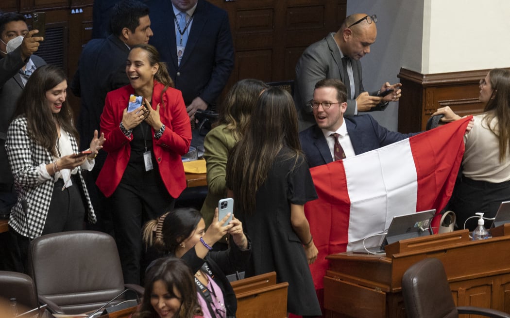 Congress members in react after the vote for the impeachment of Peru's President Pedro Castillo, on 7 December 7, 2022.