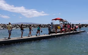 Volunteers load water onto a boat to be transported to West Maui from the Kihei boat landing.