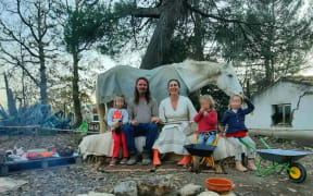 Nathan Trevallion and Catherine Birmingham pose for a picture with their children. A portion of this photo has been blurred by CNN to protect identities.