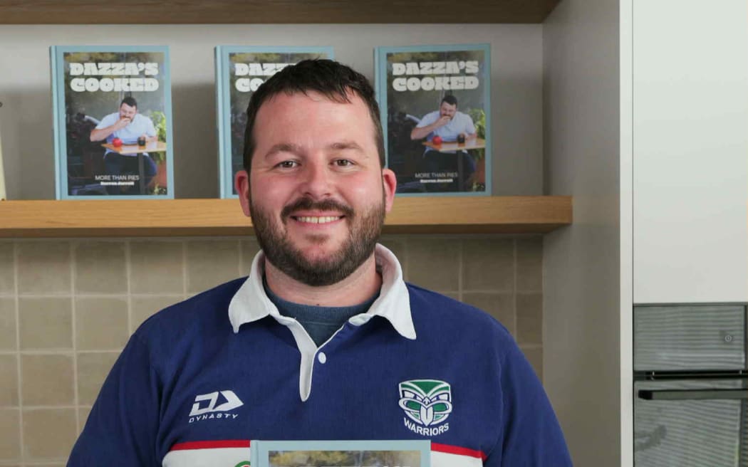 Darren Jarrett with his cookbook Dazza's Cooked