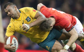 Kurtley Beale of Australia is tackled by Liam Williams of Wales