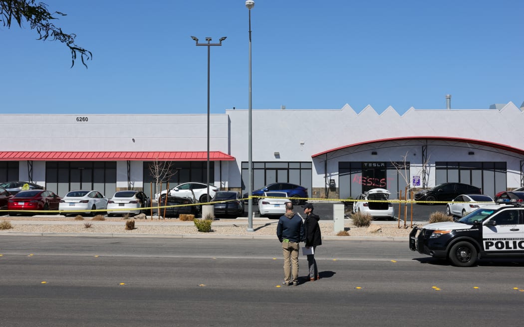 LAS VEGAS, NEVADA - MARCH 18: Investigators look over the scene at a Tesla Collision Center after an individual used incendiary devices to set several vehicles on fire on March 18, 2025 in Las Vegas, Nevada. The Las Vegas Metropolitan Police Department said that five Teslas were damaged and believe that the suspect fired three rounds from a firearm at the vehicles and spray painted the word "RESIST" on the entrance.   Ethan Miller/Getty Images/AFP (Photo by Ethan Miller / GETTY IMAGES NORTH AMERICA / Getty Images via AFP)