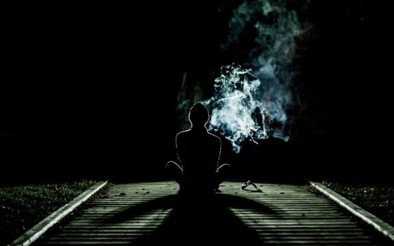 boy smoking at night