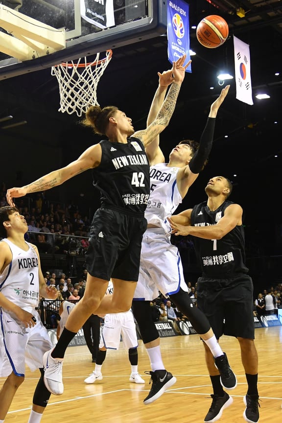 Tall Blacks forward Issac Fotu leaps for the ball against Korea.