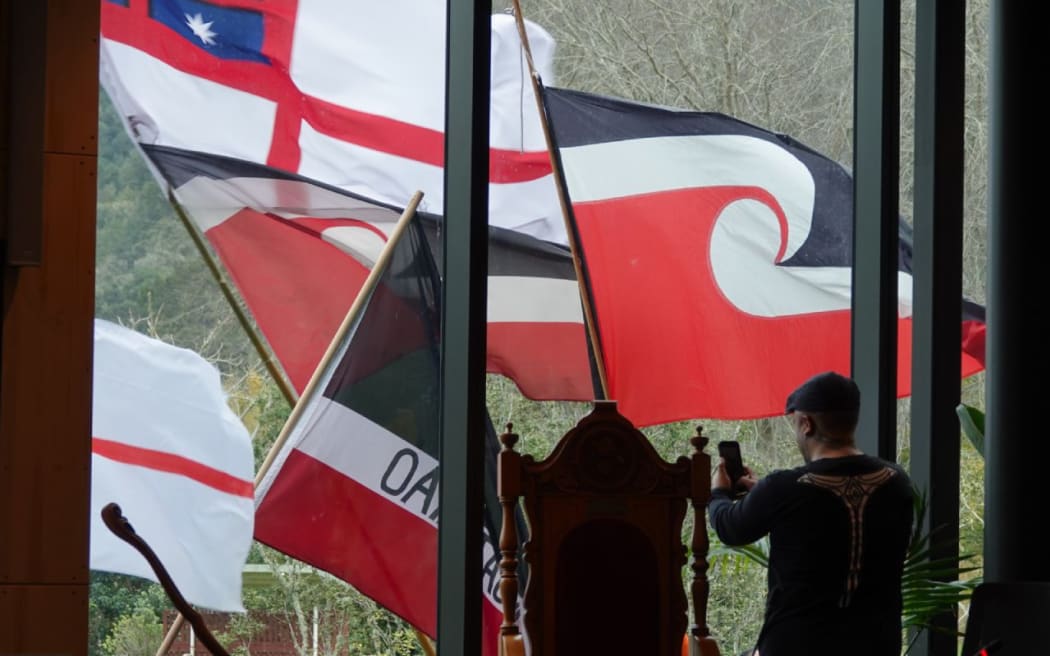 Supporters wave flags outside the council chamber windows.