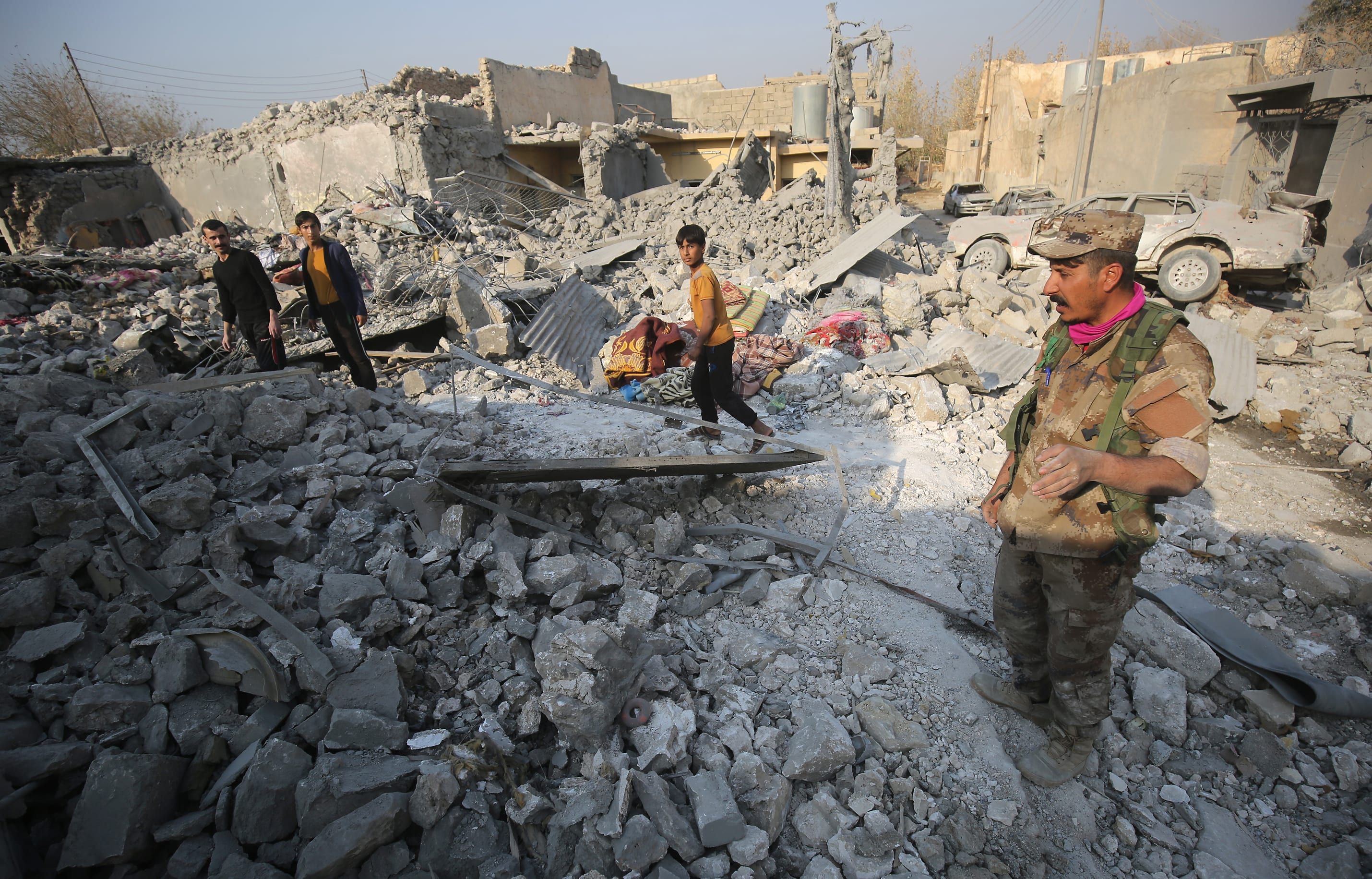 Hammam al_Alil residents inspect the damage caused by air strikes in their town, south of Mosul.