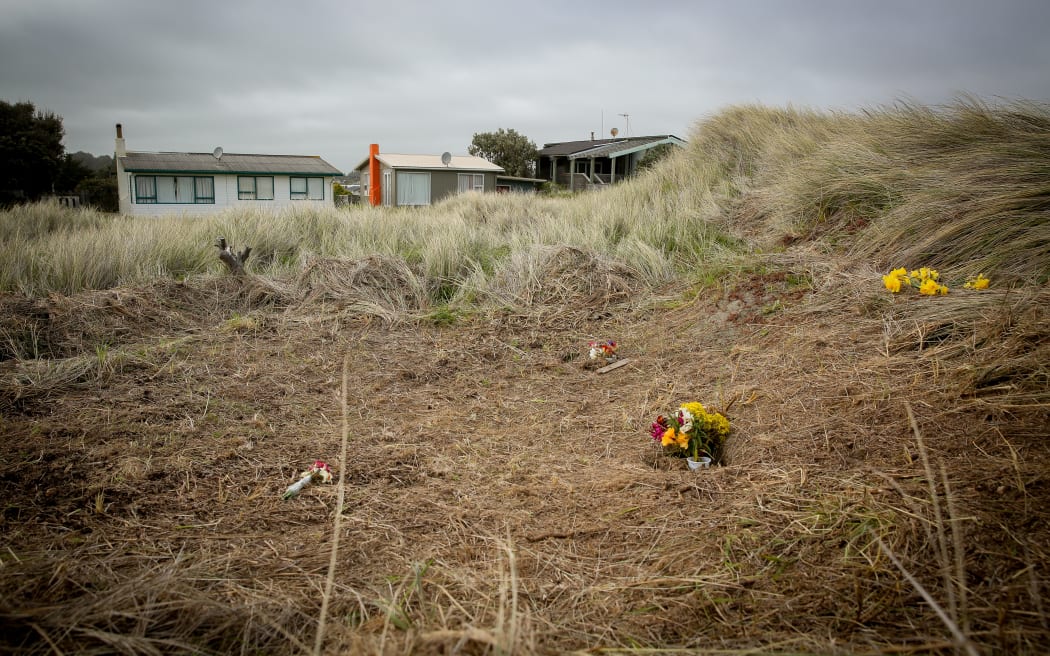 Flowers have been left on the sand dunes of Waitarere Beach where Alex Fishers body was found.
