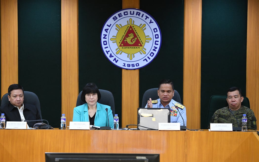 Commodore Jay Tarriela (2nd R), spokesman of Philippine Coast Guard for the West Philippine Sea (PCG-WPS), speaks during a press conference at the national security council headquarters in Manila on October 23, 2023, while Armed Forces of the Philippines spokesperson Colonel Medel Aguilar (R), Jonathan Malaya (L), Director General of the National Security Council, and Department of Foreign Affairs spokesperson Maria Teresita Daza (2nd L) listen. Manila summoned Beijing's ambassador and China lodged a complaint on 23 October in a growing spat over two collisions between Philippine and Chinese vessels in the disputed South China Sea. (Photo by Ted ALJIBE / AFP)