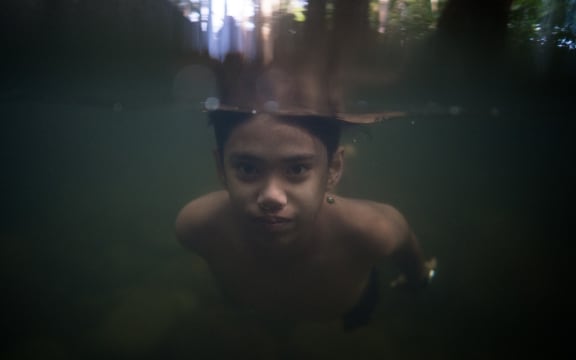 A Malaysian youth swims in a river due to the hot weather in Hulu Langat, outside Kuala Lumpur on March 2, 2015. AFP PHOTO / MOHD RASFAN (Photo by MOHD RASFAN / AFP)