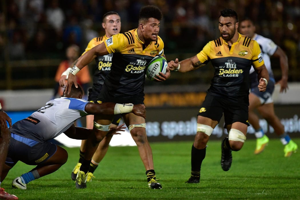 Ardie Savea (C of the Hurricanes is tackled by Solomoni (Junior Rasolea) of the Force as he looks to pass with team mate Victor Vito.