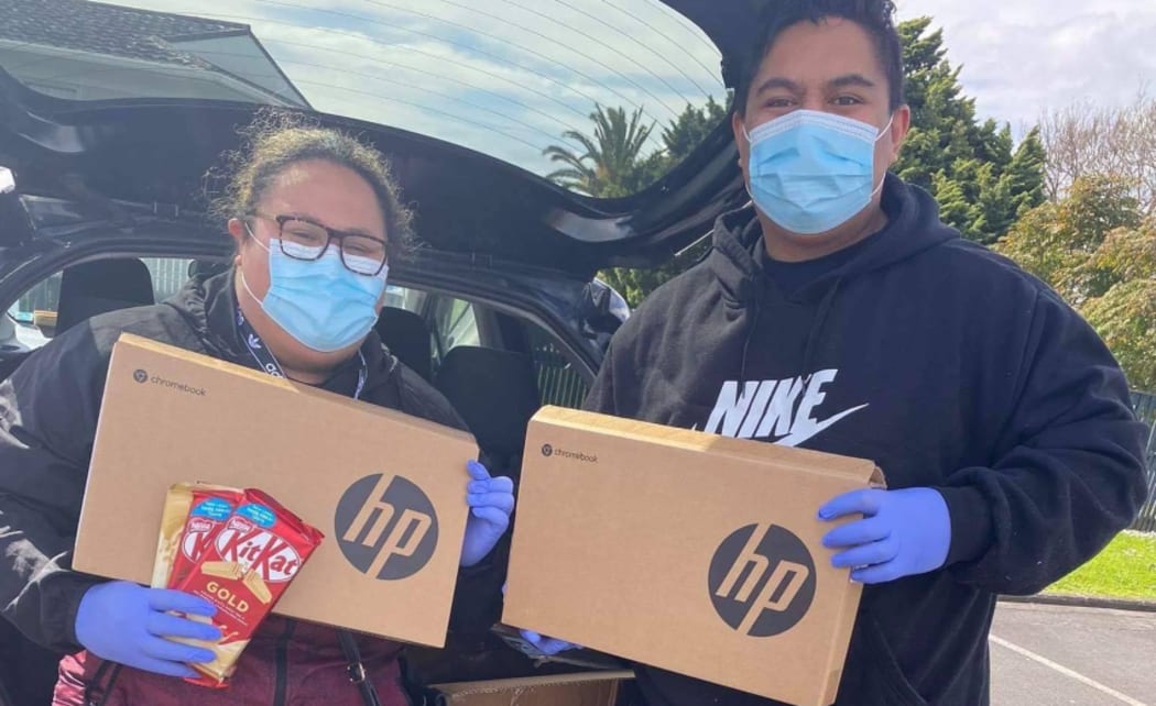 Eteroa Lafaele delivering laptops to pupils as part of her DigiTautua initiative.