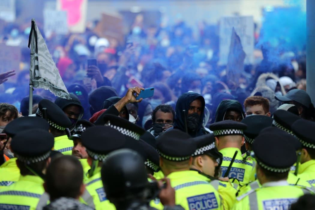 Police form a line to prevent protesters entering King Charles Street, near Whitehall in central London, 7 June 2020.