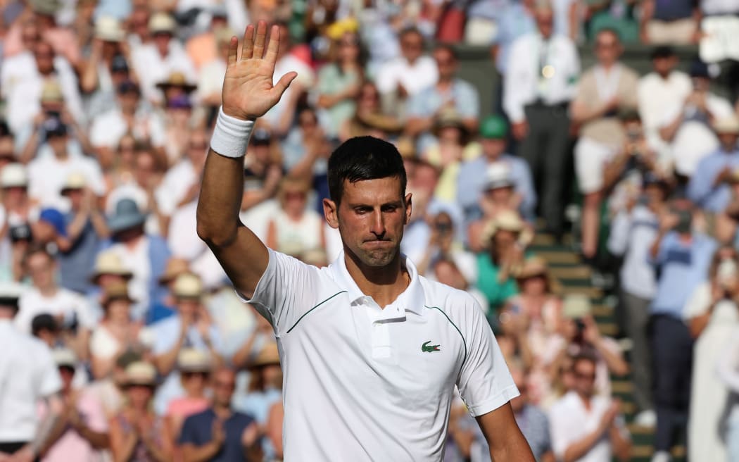 Novak Djokovic (SRB) waves to the crowd at Wimbledon 2022.