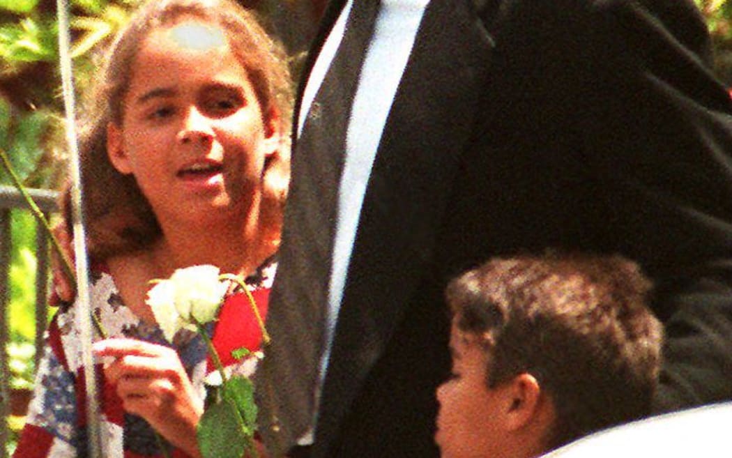 Ex-football superstar O.J.Simpson accompanies his children, Sydney, nine and Justin, six as they leave funeral services 16 June 1994 for his ex-wife, Nicole Simpson, who was slain outside her home 12 June 1994. (Photo by AFP)