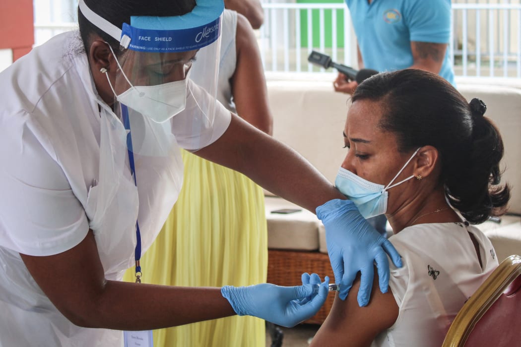 A medical personnel injects a dose of the Chinese Covid-19 vaccine produced by Sinopharm at the Seychelles Hospital in Victoria, on January 10, 2021.