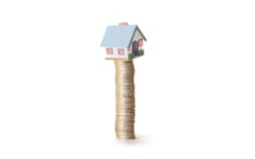House balancing on money