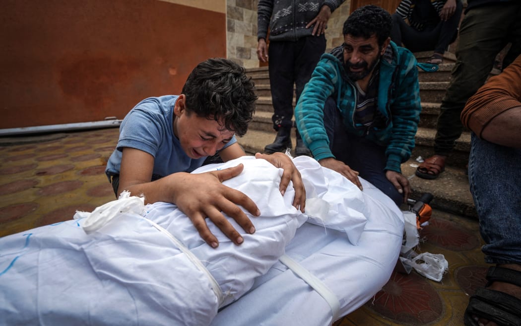A Palestinian mourns over the body of a relative killed in Israeli strike at the Nasser hospital in Khan Yunis on the southern Gaza Strip on December 28, 2023, amid continuing battles between Israel and the Palestinian militant group Hamas. (Photo by AFP)
