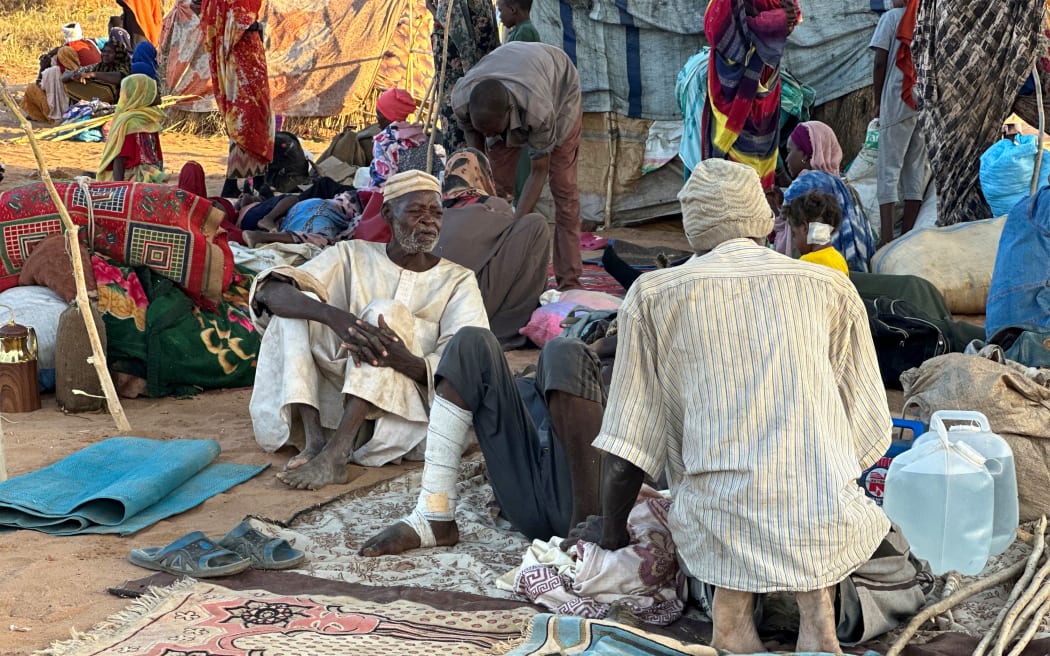 Displaced Sudanese who fled El-Fasher after the city fell to the Rapid Support Forces (RSF), rest near the town of Tawila in war-torn Sudan's western Darfur region on October 28, 2025. Fears mounted in Sudan on October 28, three days after paramilitaries seized the key city of El-Fasher, amid reports of mass atrocities and the killing of five Red Crescent volunteers in Kordofan. The capture of El-Fasher, the historic heart of Darfur, has sparked fears of mass killings reminiscent of the region’s darkest days. (Photo by AFP)