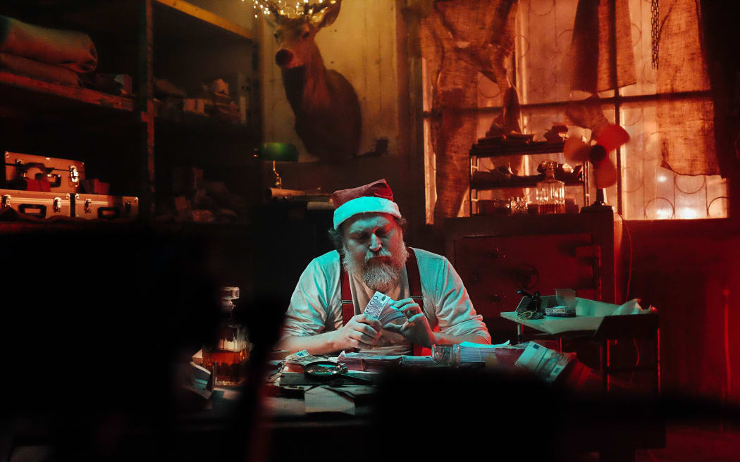 Man in a Santa suit counting money
