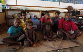 Ralph and Mary Yalu and their family at the Freswota Evacuation Centre. They lost everything in the cyclone but gained a new family member inside the blue mosquito net who was born during the Cyclone. They named her Pamina.