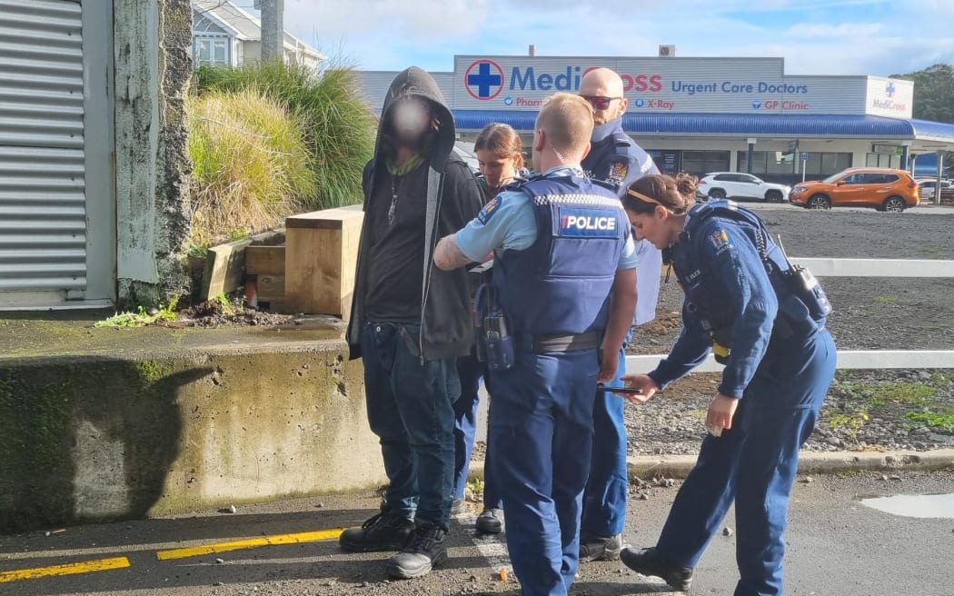 Police officers arrest a man outside New Plymouth's Puke Ariki after being reported for waving nunchucks around.