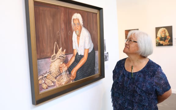 Rovina Tata next to the portrait of her Kuia Makarita Hose.