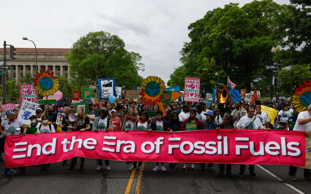 WASHINGTON, DC - APRIL 22: Activists participate in an Earth Day march titled “End the Era of Fossil Fuels,” to the White House on April 22, 2023 in Washington, DC. Activists with climate, peace, racial justice, and economic justice groups gathered in downtown DC to listen to speeches and march to the White House   Anna Moneymaker/Getty Images/AFP (Photo by Anna Moneymaker / GETTY IMAGES NORTH AMERICA / Getty Images via AFP)