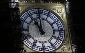 The clock face of Elizabeth Tower, known more commonly after the name of bell inside, Big Ben, shows the hands at eleven o'clock at night, at the Houses of Parliament in central London on January 31, 2020.