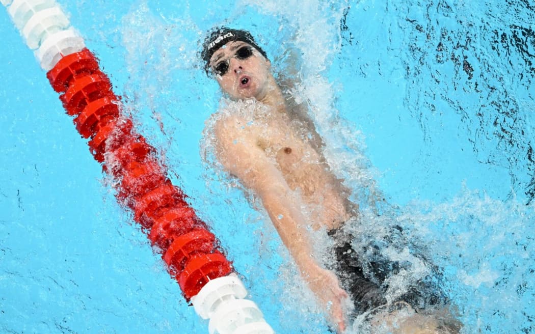 An overview shows New Zealand's Kane Follows competing in a heat of the men's 200m backstroke swimming event during the Paris 2024 Olympic Games at the Paris La Defense Arena in Nanterre, west of Paris, on July 31, 2024. (Photo by François-Xavier MARIT / AFP)