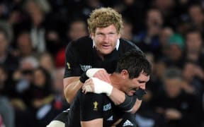 Adam Thomson jumps on Stephen Donald at the end of the New Zealand All Blacks v France Rugby World Cup Final 2011.
