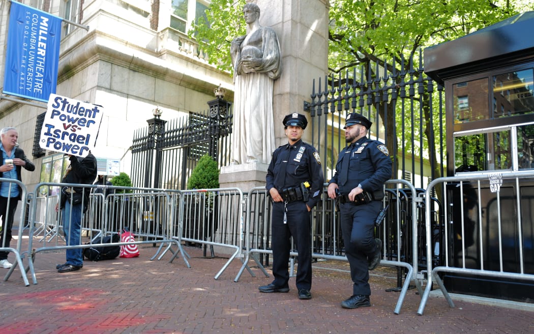 NYPD officers stand at the entrance of Columbia University in New York City on May 1, 2024. Clashes broke out on Wednesday at pro-Palestinian demonstrations on the campus of the University of California, Los Angeles, as dozens of universities around the United States struggle to contain similar protests. (Photo by CHARLY TRIBALLEAU / AFP)