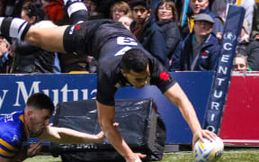 New Zealand's Jordan Kahu scores a try.