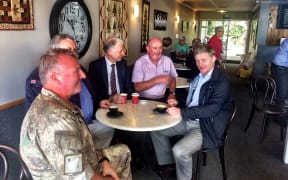 Prime Minister Bill English (far right) takes a break at a local cafe in Kaikōura.