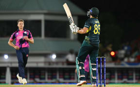 Australia's Tim David hits the winning shot during the ICC men's Twenty20 World Cup 2024 group B cricket match between Australia and Scotland at Daren Sammy Cricket Ground in Gros Islet, St. Lucia, June 15, 2024. (Photo by TIMOTHY A. CLARY / AFP)