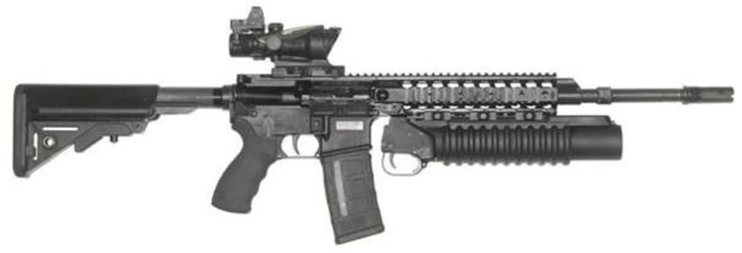 The LMT MARS-L with magazine, standard ACOG 4 power optical sight and grenade launcher mounted, and butt stock fully extended.